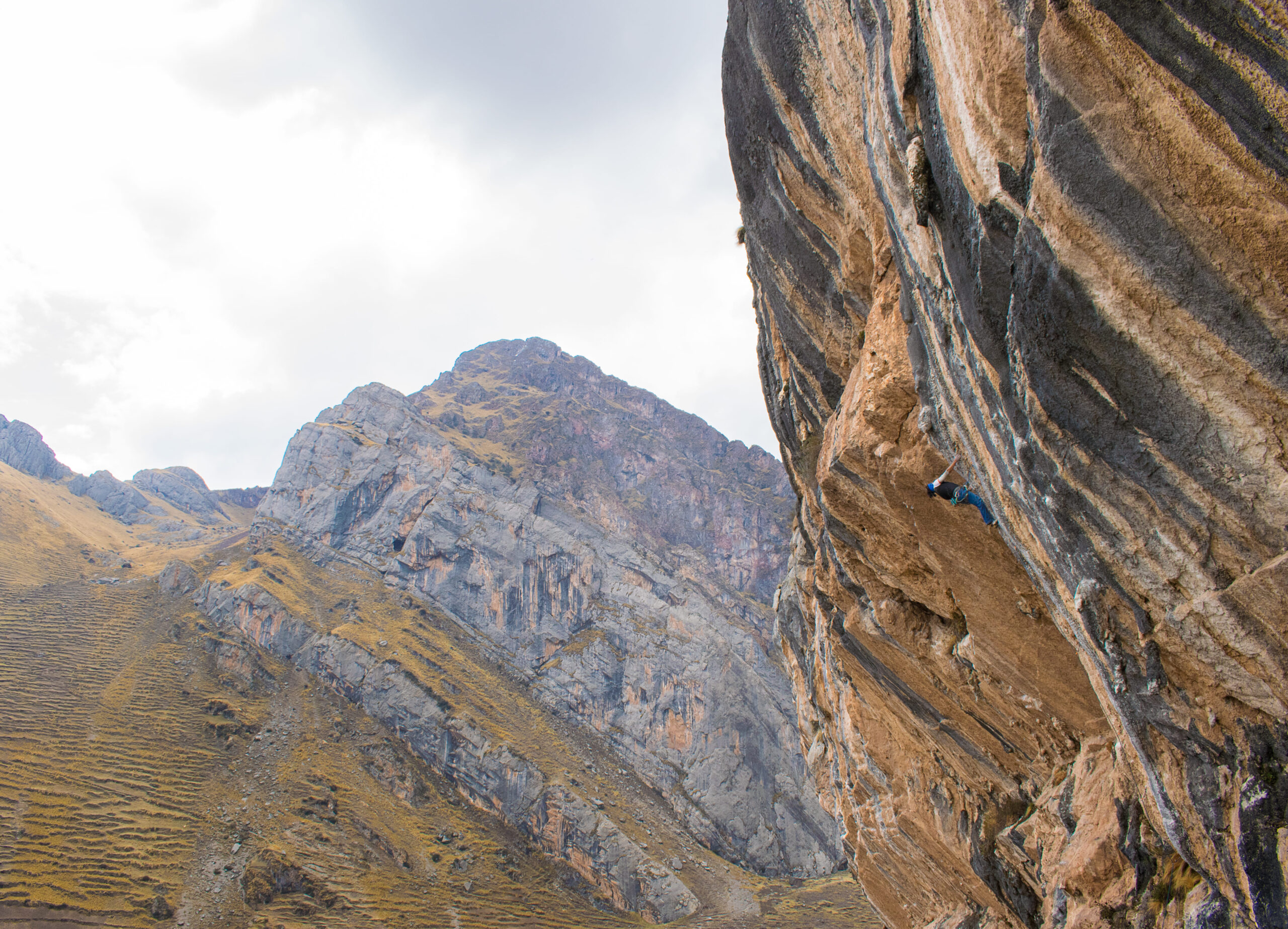 stunning landscape with climber pushing on limestone during rock climbing tour with Alejandro Cornejo and Climbing Rooftop in Pitumarca Cusco Peru