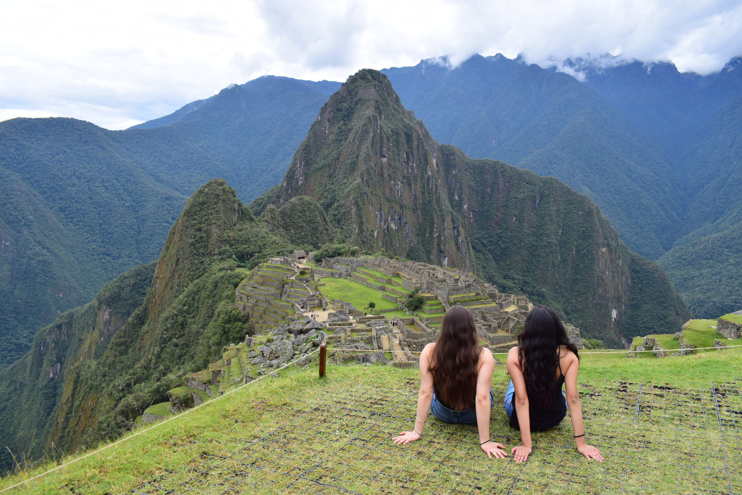 female travelers in Machu picchu during Salkantay trekking after Rock climbing tour to Macchu Picchu with Alejandro Cornejo operate by sky viajes and Peru climb