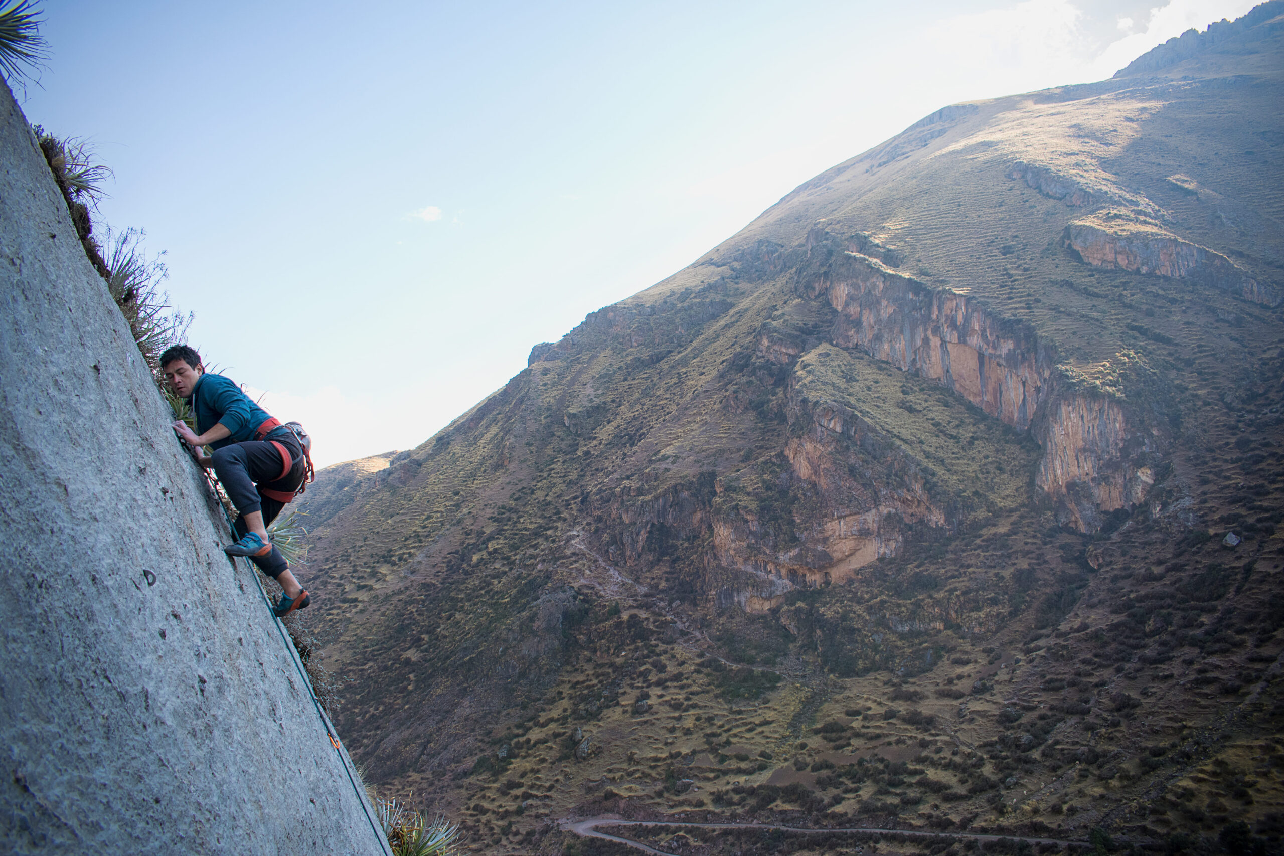pushing on slab quality limestone during rock climbing tour with Alejandro Cornejo and Climbing Rooftop in Pitumarca Cusco Peru